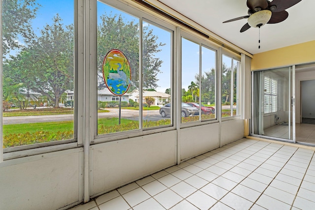 unfurnished sunroom with ceiling fan