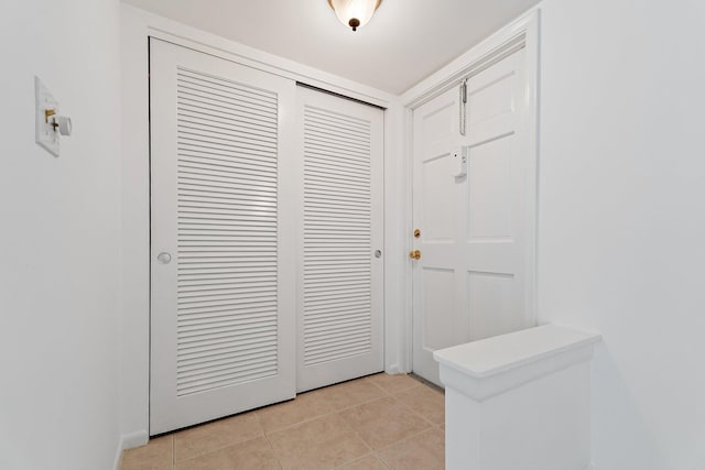 foyer entrance featuring light tile patterned flooring
