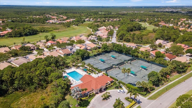 aerial perspective of suburban area featuring a pool area and a golf course