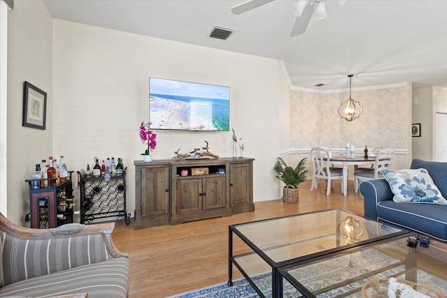 living area with light wood-type flooring and a ceiling fan