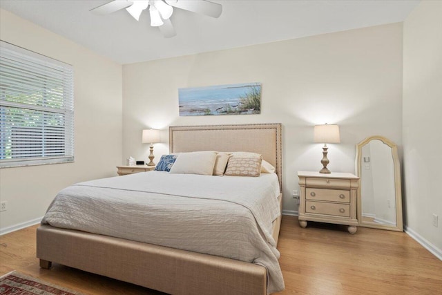 bedroom with wood finished floors, baseboards, and ceiling fan