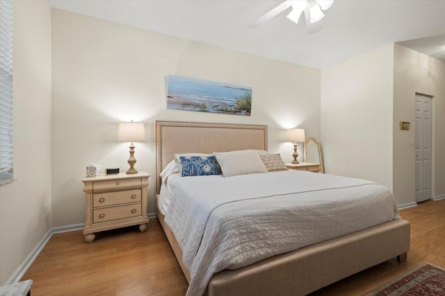 bedroom with light wood-type flooring, baseboards, and a ceiling fan