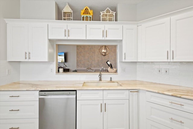 kitchen with dishwasher, a sink, white cabinets, decorative backsplash, and light stone countertops