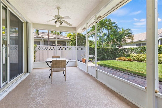 sunroom featuring a ceiling fan