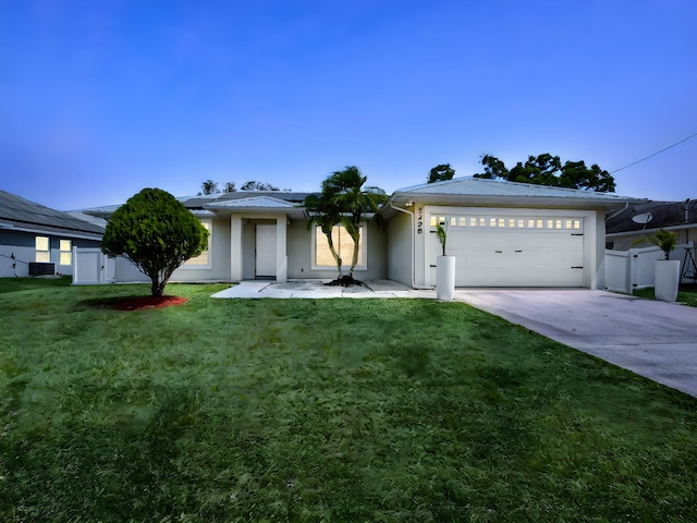 5298 NW N Macedo Blvd, Port Saint Lucie, FL 34983 - ranch-style home with concrete driveway, an attached garage, roof mounted solar panels, stucco siding, and metal roof