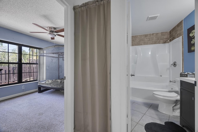 bathroom featuring a ceiling fan, toilet, vanity,  shower combination, and tile patterned floors