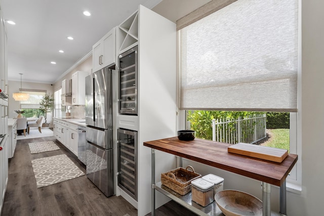 kitchen with appliances with stainless steel finishes, beverage cooler, white cabinetry, recessed lighting, and dark wood finished floors