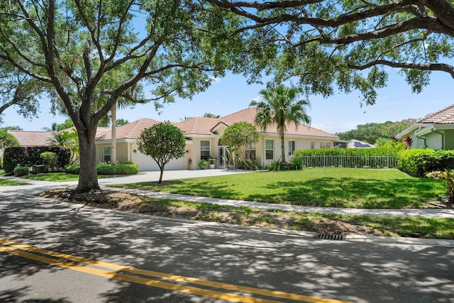 view of front of property featuring stucco siding, a tile roof, driveway, and an attached garage