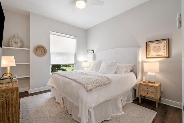 bedroom featuring wood finished floors, baseboards, and a ceiling fan