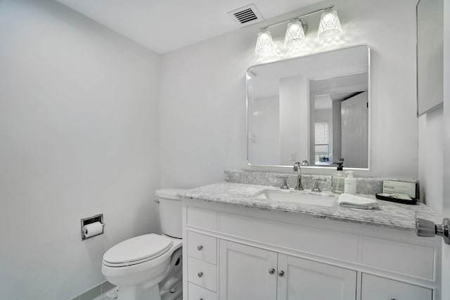 bathroom with toilet and vanity