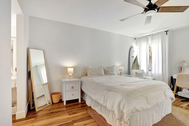 bedroom with light wood-style floors and a ceiling fan