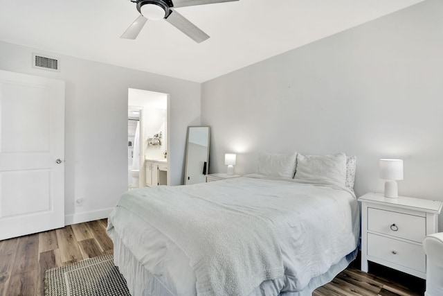 bedroom featuring wood finished floors, connected bathroom, baseboards, and a ceiling fan