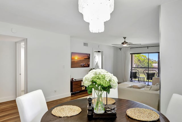 dining space featuring baseboards, wood finished floors, and ceiling fan