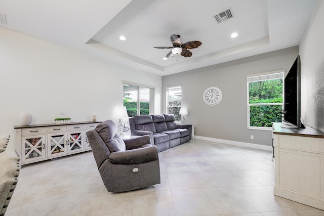 10250 SW Azzo Ln, Port Saint Lucie, FL 34986 - living room featuring a tray ceiling, ceiling fan, healthy amount of natural light, recessed lighting, and light tile patterned floors