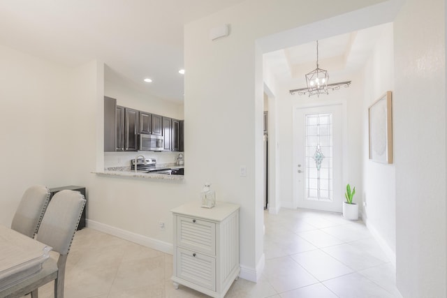 10250 SW Azzo Ln, Port Saint Lucie, FL 34986 - entrance foyer featuring a chandelier, light tile patterned floors, baseboards, and recessed lighting