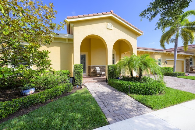 10250 SW Azzo Ln, Port Saint Lucie, FL 34986 - view of front facade with stucco siding, a tiled roof, and driveway