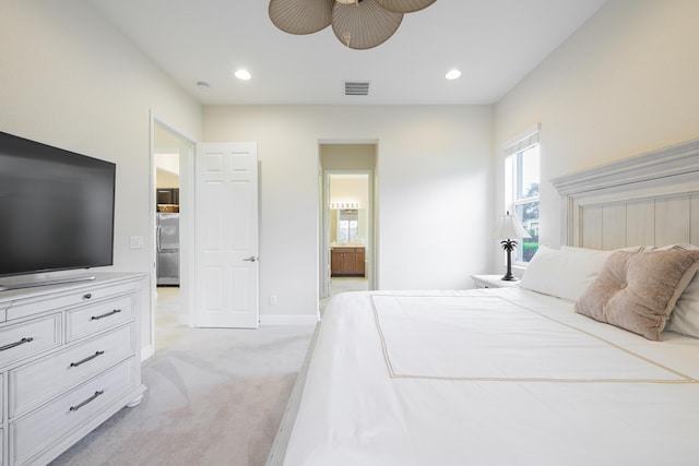 10250 SW Azzo Ln, Port Saint Lucie, FL 34986 - bedroom with light carpet, stainless steel refrigerator, recessed lighting, ensuite bath, and baseboards