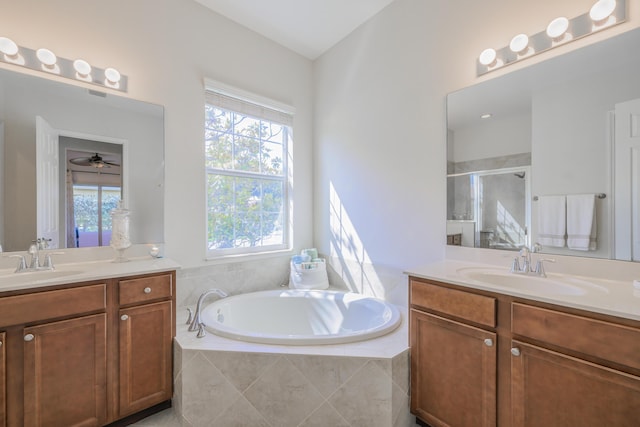 10250 SW Azzo Ln, Port Saint Lucie, FL 34986 - full bath featuring a shower stall, two vanities, a garden tub, and a ceiling fan