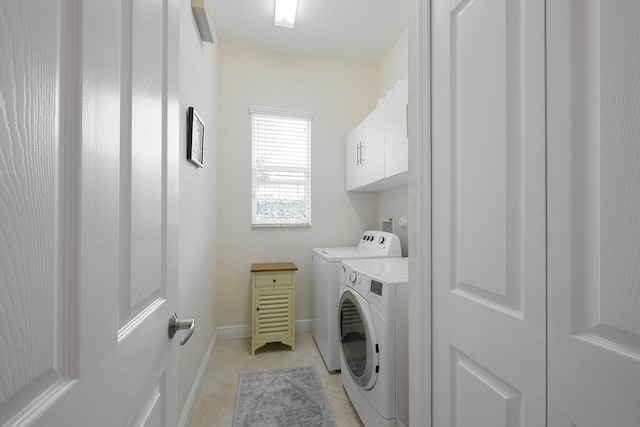 10250 SW Azzo Ln, Port Saint Lucie, FL 34986 - laundry area featuring cabinet space, washer and dryer, light tile patterned flooring, and baseboards