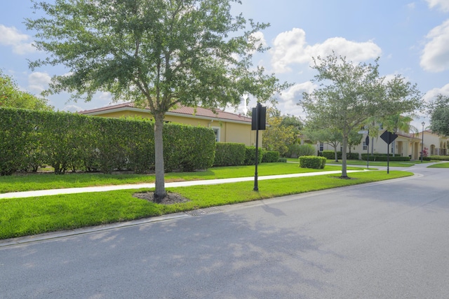 10250 SW Azzo Ln, Port Saint Lucie, FL 34986 - view of front of home featuring a front lawn and stucco siding