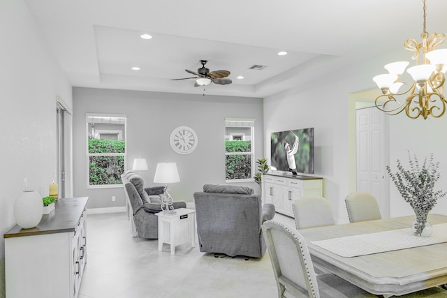 10250 SW Azzo Ln, Port Saint Lucie, FL 34986 - dining space featuring a chandelier, a tray ceiling, baseboards, ceiling fan, and recessed lighting