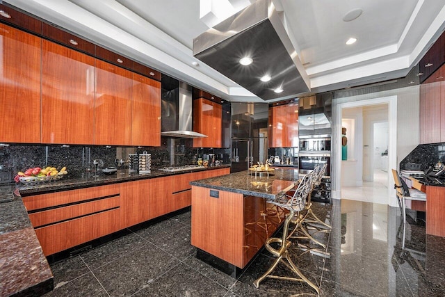 3066 SE Dune Dr, Stuart, FL 34996 - kitchen with granite floors, wall chimney range hood, white gas stovetop, modern cabinets, and decorative backsplash