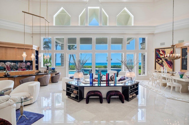 3066 SE Dune Dr, Stuart, FL 34996 - living area with a towering ceiling, a chandelier, and crown molding