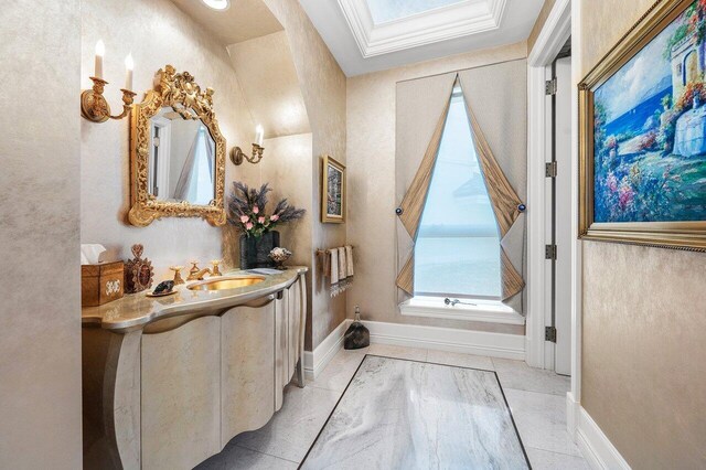 3066 SE Dune Dr, Stuart, FL 34996 - bathroom with baseboards, vanity, and a skylight