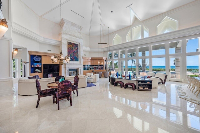 3066 SE Dune Dr, Stuart, FL 34996 - dining space featuring a high ceiling, healthy amount of natural light, a high end fireplace, a water view, and crown molding