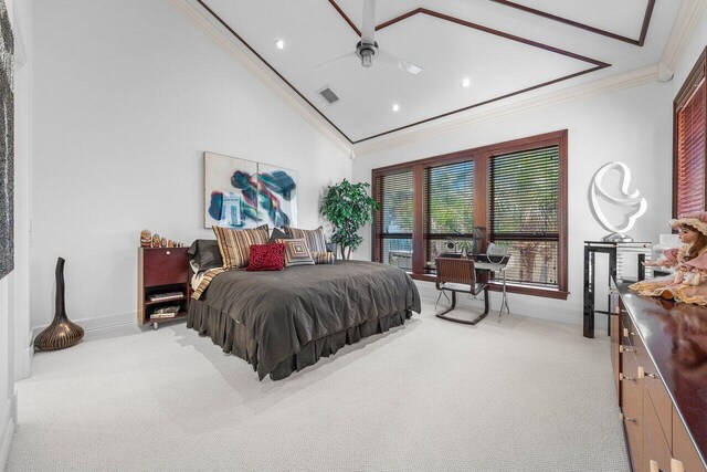 3066 SE Dune Dr, Stuart, FL 34996 - bedroom with crown molding, baseboards, light colored carpet, vaulted ceiling, and recessed lighting