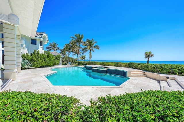 3066 SE Dune Dr, Stuart, FL 34996 - view of pool with a patio, a pool with connected hot tub, and a water view