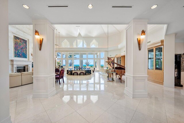 3066 SE Dune Dr, Stuart, FL 34996 - lobby featuring ornamental molding, a decorative wall, and recessed lighting