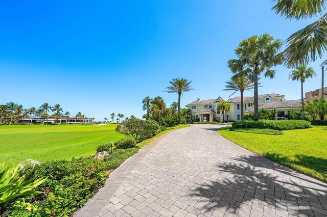 3066 SE Dune Dr, Stuart, FL 34996 - view of front of house with a front lawn and decorative driveway