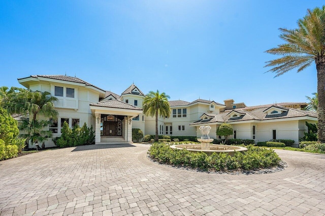 3066 SE Dune Dr, Stuart, FL 34996 - view of front of home featuring curved driveway and stucco siding
