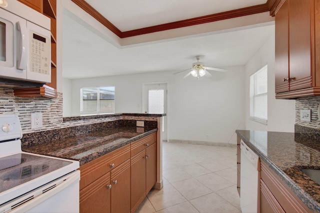 228 Brittany E, Delray Beach, FL 33446 - kitchen with white appliances, backsplash, ceiling fan, plenty of natural light, and crown molding