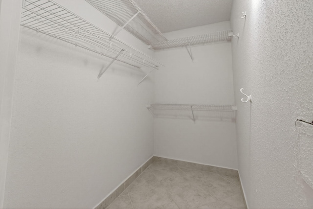 228 Brittany E, Delray Beach, FL 33446 - walk in closet with light tile patterned floors