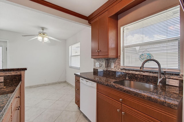 228 Brittany E, Delray Beach, FL 33446 - kitchen featuring white dishwasher, a ceiling fan, dark stone counters, light tile patterned floors, and decorative backsplash