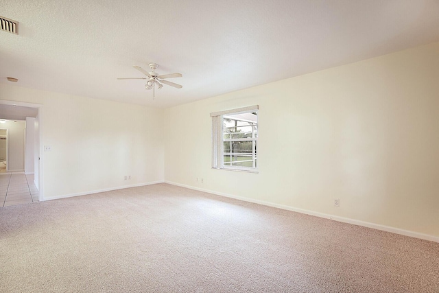 16594 90th St N, Loxahatchee, FL 33470 - spare room with light colored carpet, a ceiling fan, and baseboards