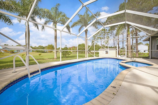 16594 90th St N, Loxahatchee, FL 33470 - view of pool with a storage unit, an outbuilding, a patio area, a pool with connected hot tub, and a lanai