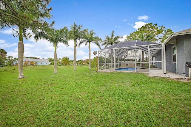 16594 90th St N, Loxahatchee, FL 33470 - view of green lawn featuring a patio area, glass enclosure, and an outdoor pool