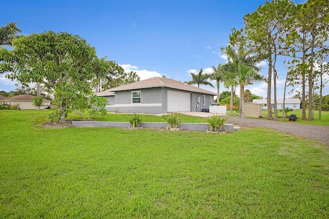 16594 90th St N, Loxahatchee, FL 33470 - view of property exterior with driveway, a lawn, stucco siding, and an attached garage