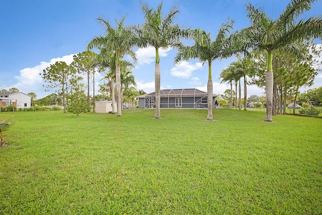 16594 90th St N, Loxahatchee, FL 33470 - view of green lawn with a lanai, a shed, and an outbuilding