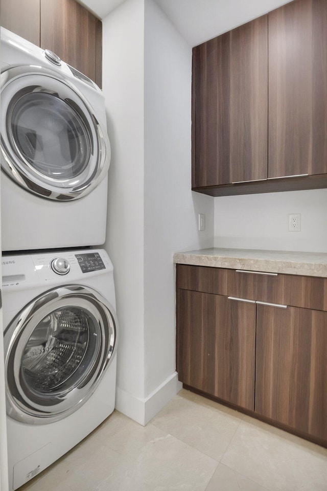 21922 Cypress Dr Unit 37B, Boca Raton, FL 33433 - laundry area with stacked washer / dryer, cabinet space, and baseboards