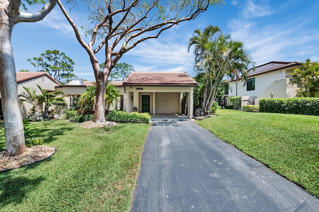 21922 Cypress Dr Unit 37B, Boca Raton, FL 33433 - mediterranean / spanish-style house with a tile roof, asphalt driveway, a front lawn, stucco siding, and a carport