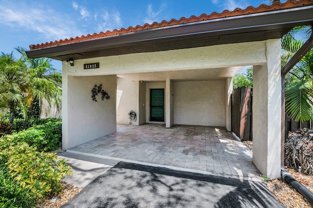 21922 Cypress Dr Unit 37B, Boca Raton, FL 33433 - property entrance featuring a carport, stucco siding, and a tile roof