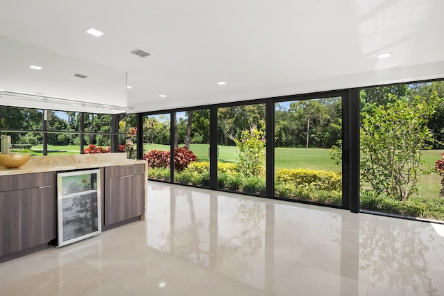 21922 Cypress Dr Unit 37B, Boca Raton, FL 33433 - unfurnished sunroom featuring beverage cooler and view of wooded area