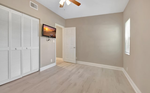 7655 Cinebar Dr Unit 105, Boca Raton, FL 33433 - unfurnished bedroom with light wood finished floors, a closet, baseboards, and a ceiling fan