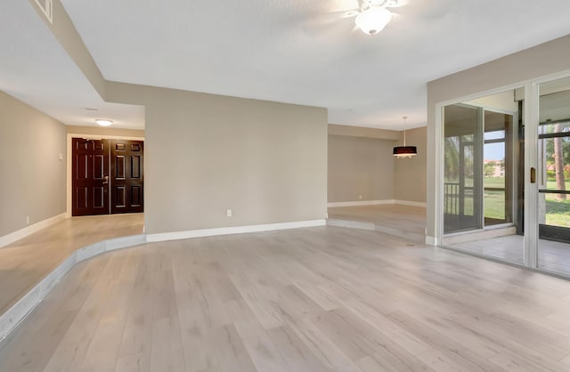 7655 Cinebar Dr Unit 105, Boca Raton, FL 33433 - unfurnished living room with light wood finished floors and baseboards