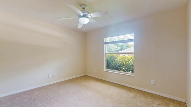 unfurnished room featuring light carpet, baseboards, and ceiling fan