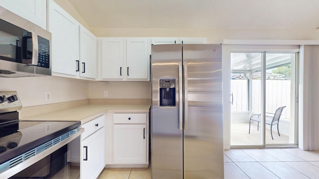 kitchen featuring stainless steel appliances, light tile patterned floors, white cabinets, and light countertops